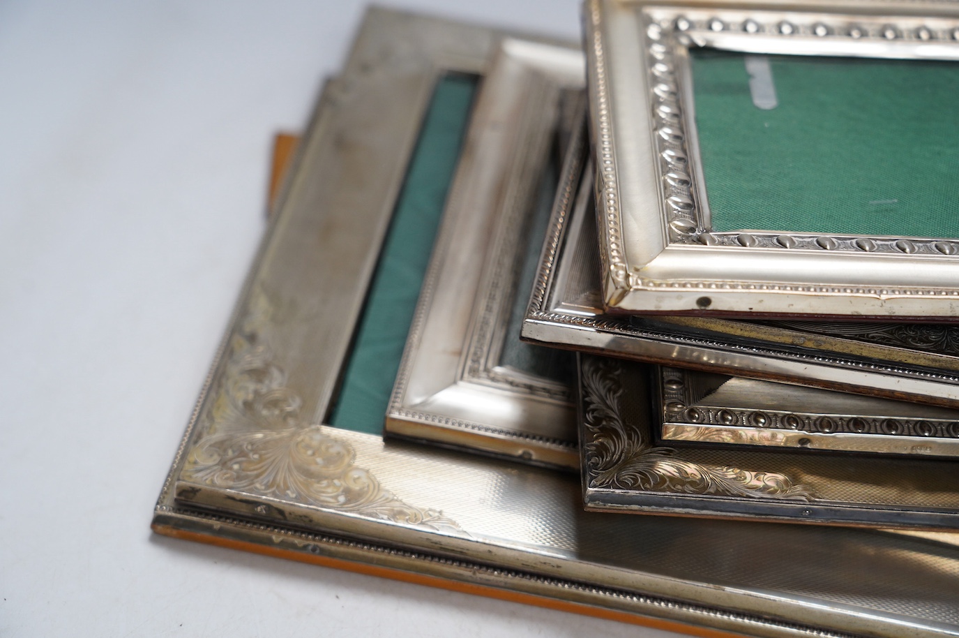 Nine assorted late 20th century 800 standard white metal mounted photograph frames, mainly Italian, including a double frame, largest 29.6cm. Condition - poor to fair